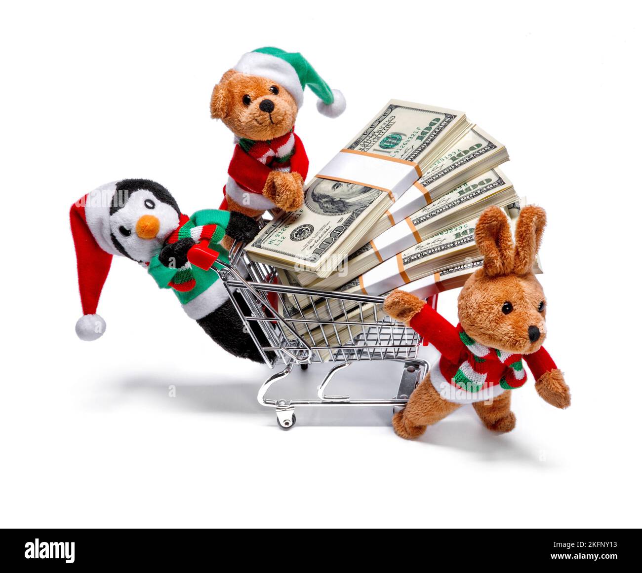 Die Helfer des Weihnachtsmannes mit einem Einkaufswagen voller Geld. Witziges Weihnachtskonzept Stockfoto