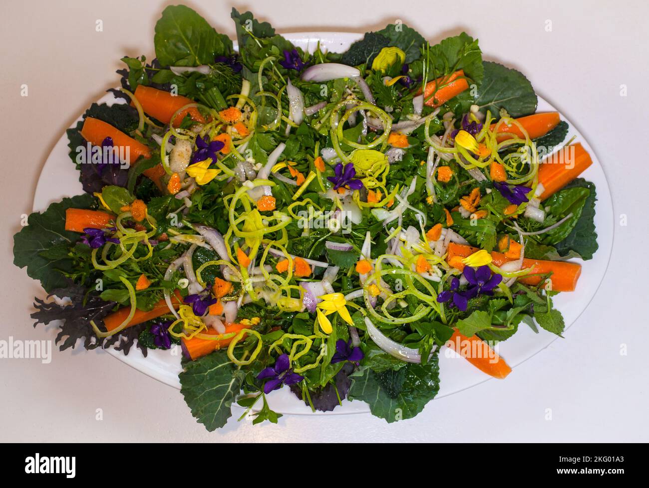 Ein Blick auf das Leben in Neuseeland: Essbare Blumen schmücken einen gesunden, frischen Gartensalat. Ich esse gut. Stockfoto