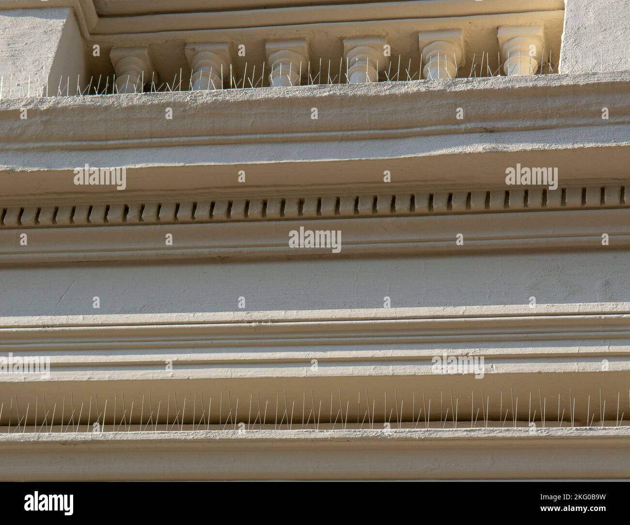 Vogelkontrollspitzen, Anti-Roosting-Spitzen, Taubenspitzen oder Roost-Modifikation an der Fassade eines Gebäudes. Stockfoto