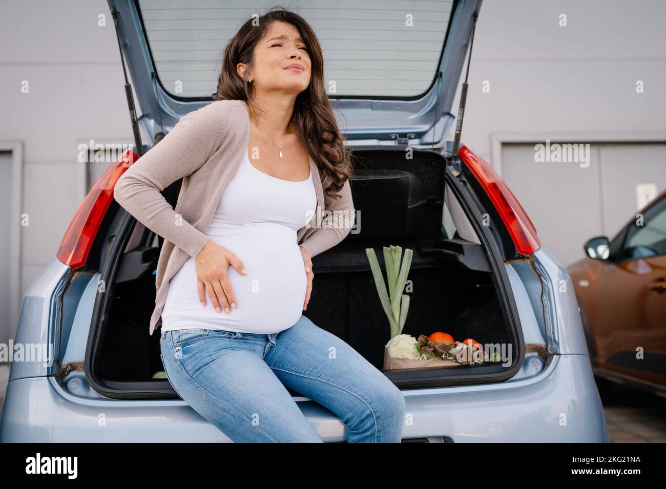 Zukünftiger Mutterschmerz im Bauch während des Entbindungseinkaufs. Stockfoto
