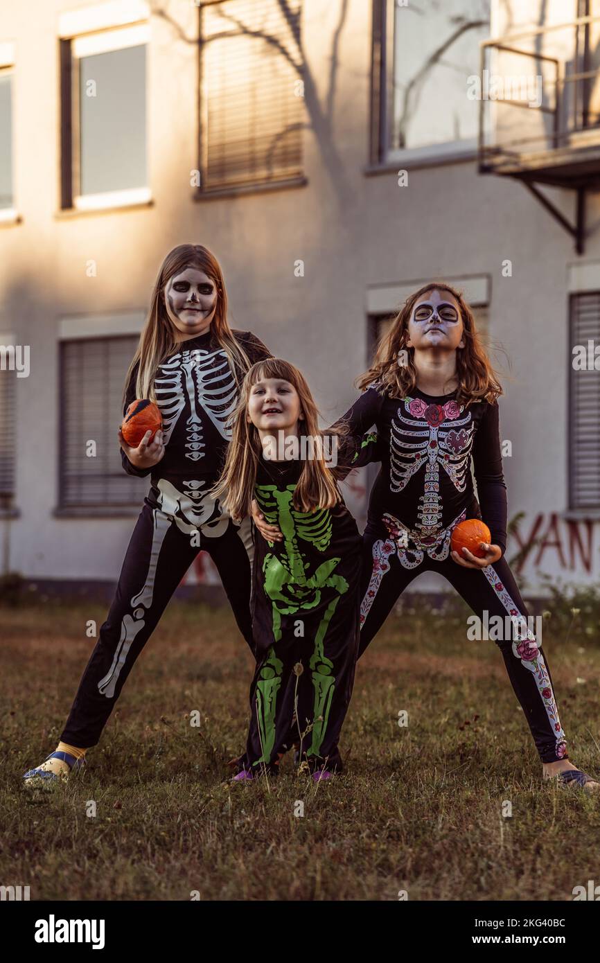 Kinder feiern eine Halloween-Kostümparty im Garten Stockfoto