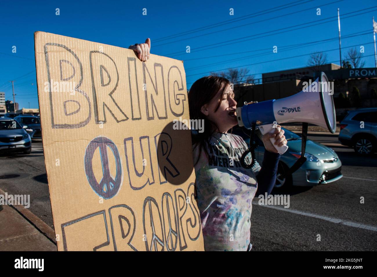 01-04-2020 Tulsa USA Potestor mit Megafon und großem selbstgemachten Schild mit der Aufschrift "Bring unsere Truppen nach Hause" an der Straßenecke Stockfoto