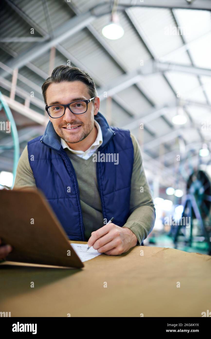 Papierpfad der Bestellung wird überprüft. Ein Mann, der in einem großen Lager arbeitet. Stockfoto