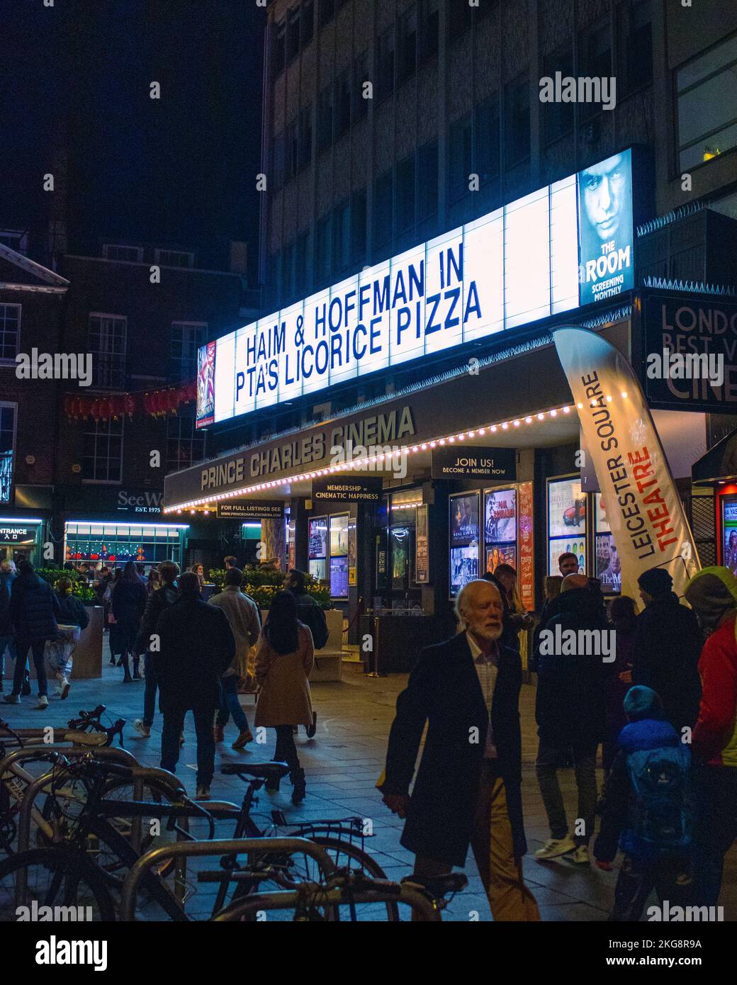 Eine Straßenszene mit einem Kinoschild, beleuchtet mit einem Markierungsschild mit der Aufschrift Hoffman in Liquorice Pizza Stockfoto