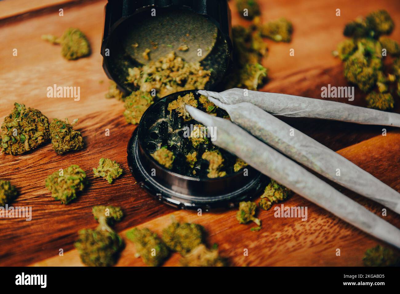 Schleifer Nahschuss, Gras und Kegel, Drogen im Gelenk auf einem Holztisch Stockfoto