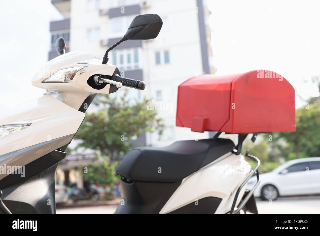 Weißer Roller mit rotem Kofferraum für Lebensmittel oder Pakete Stockfoto