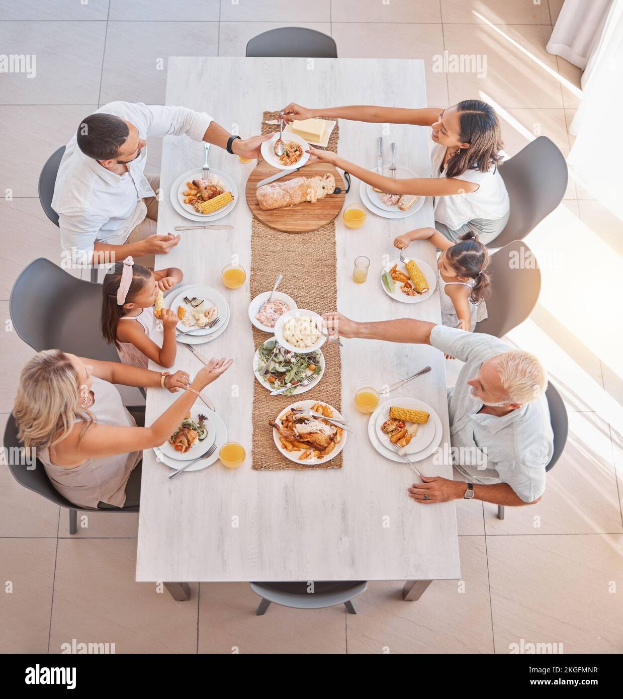 Familie, Essen und Mittagessen mit Liebe und Sorgfalt am Esstisch zum Essen und Trinken. Gruppe, Großeltern und Eltern mit Kindern, die eine köstliche Mahlzeit essen Stockfoto