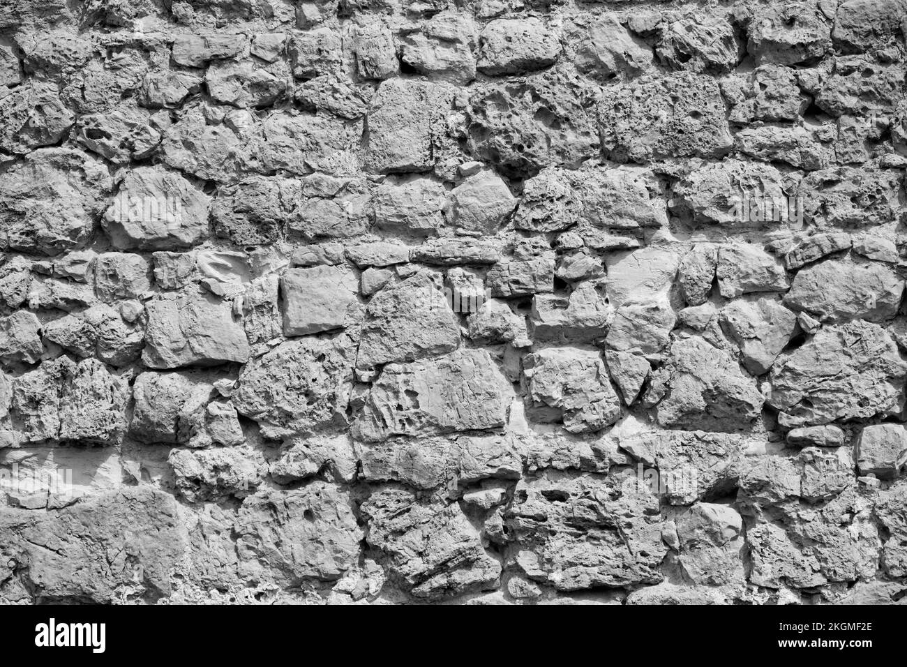 Graue rustikale Steinmauer. Stockfoto