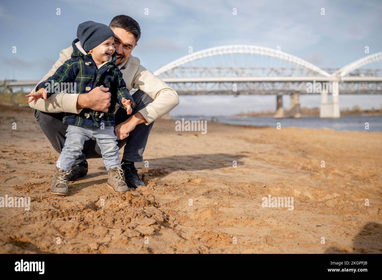Glücklicher Vater mit Sohn am Strand an einem sonnigen Tag Stockfoto