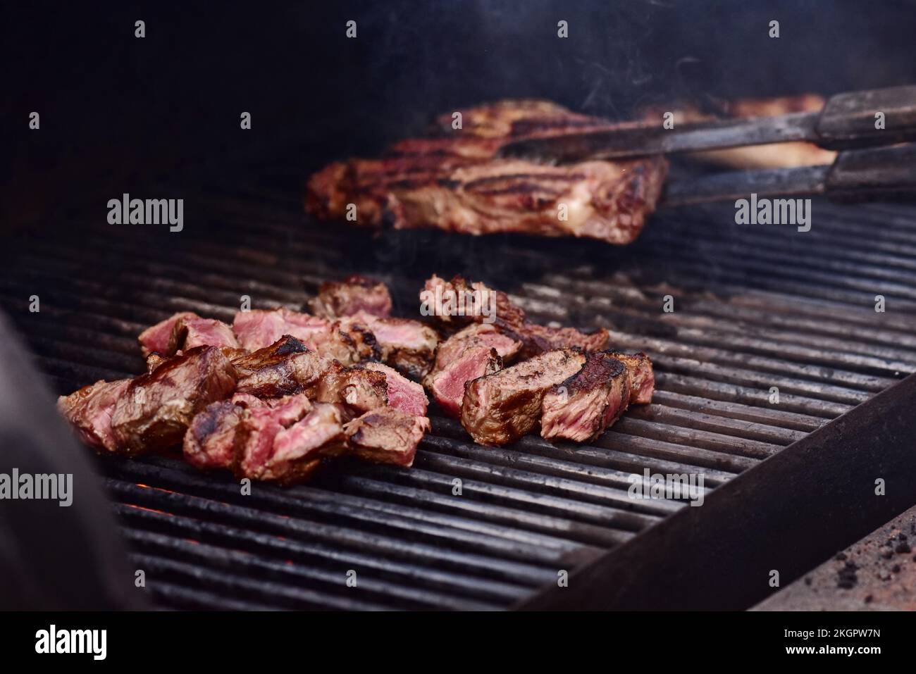 Gegrillte, saftige Rindersteaks. Aromatisches rosa Rindfleisch, auf dem Grill ausgestellt. Stockfoto