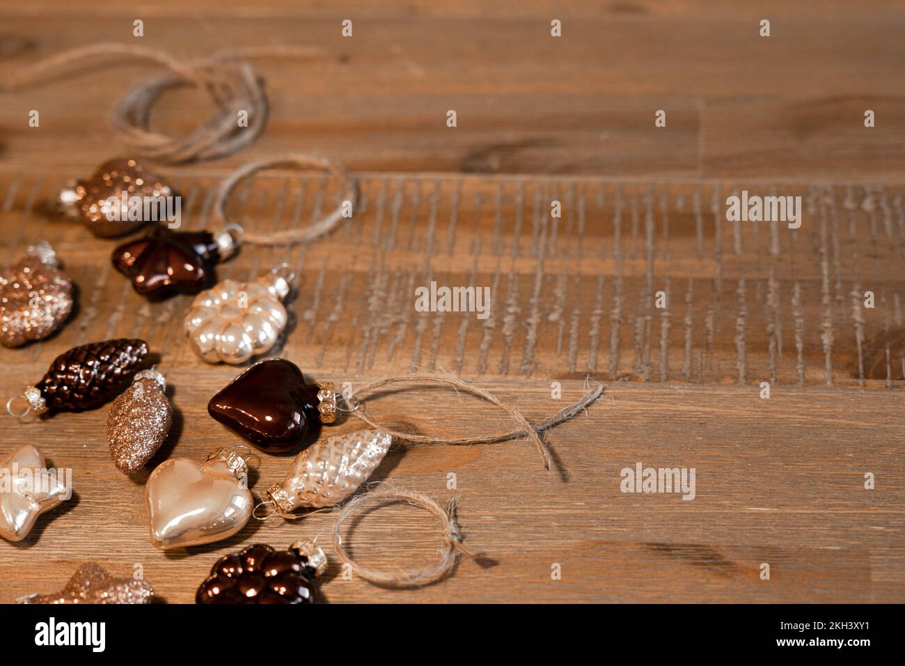 Weihnachtsbaumschmuck in natürlichen Farben liegt auf einem wunderschönen Holztisch Stockfoto