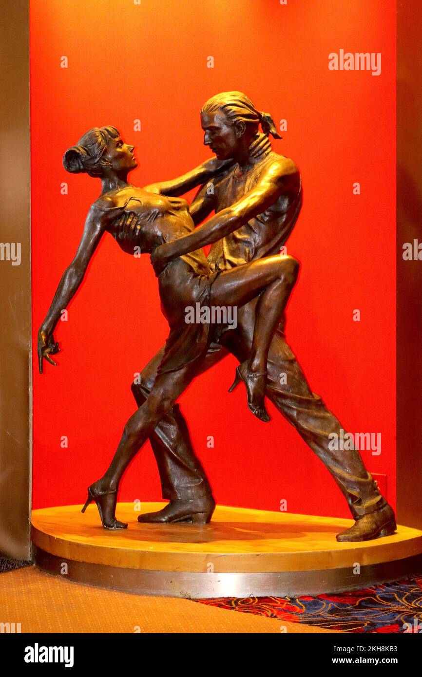 „Tango“ eine lebensgroße Bronzeskulptur von Les Johnson, die verschiedene Tanzstile außerhalb des Carmens-Tanzplatzes an Bord des Kreuzfahrtschiffs Aurora veranschaulicht. Stockfoto
