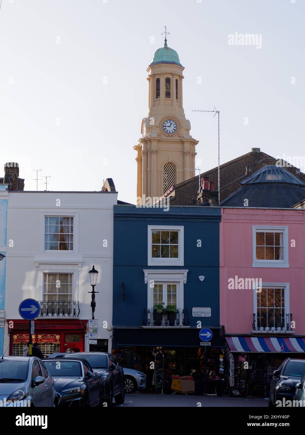 Farbenfrohe Geschäfte auf der Portabello Road mit dem Turm der St. Peters Church dahinter, Notting Hill, London. Stockfoto
