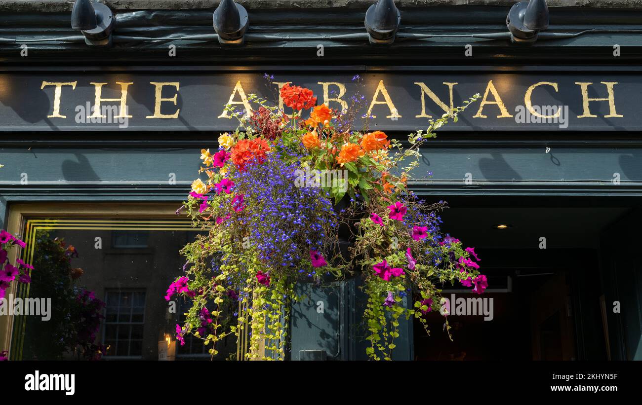 Am Eingang des Albanach, einer traditionellen schottischen Bar und Restaurant an der Royal Mile von Edinburgh, hängt ein farbenfroher Korb. Stockfoto