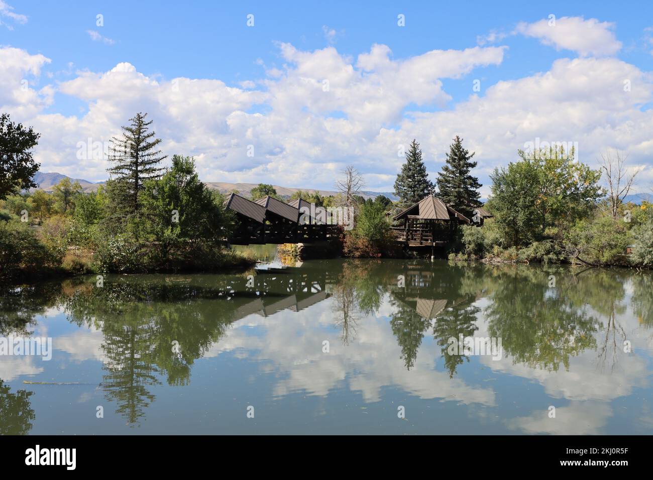 Ein wunderschöner Blick auf Holzhäuser und Bäume, die sich in einem See im Addenbrooke Park, Lakewood, spiegeln Stockfoto