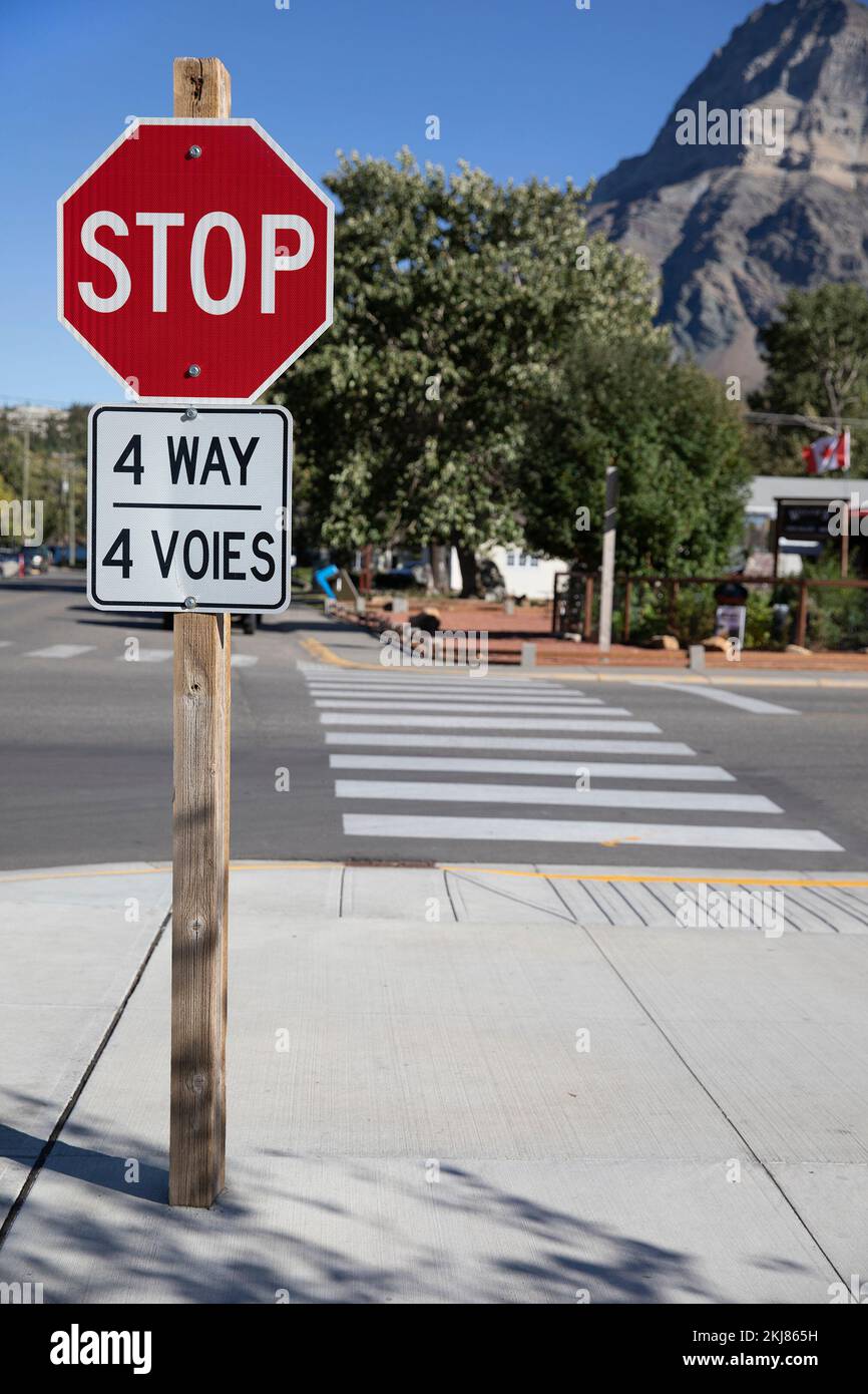 Stoppschild mit zweisprachigen Wörtern auf Englisch und Französisch, 4 Way und 4 voies, Waterton, Kanada Stockfoto