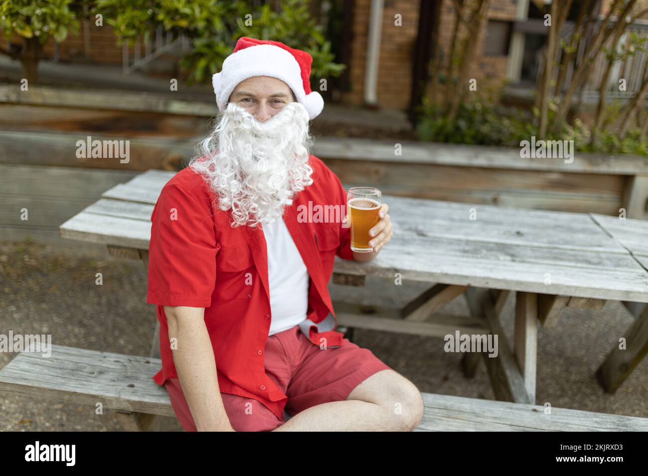 Ein Weihnachtsmann zu Weihnachten im australischen Sommer mit einem Bier Stockfoto