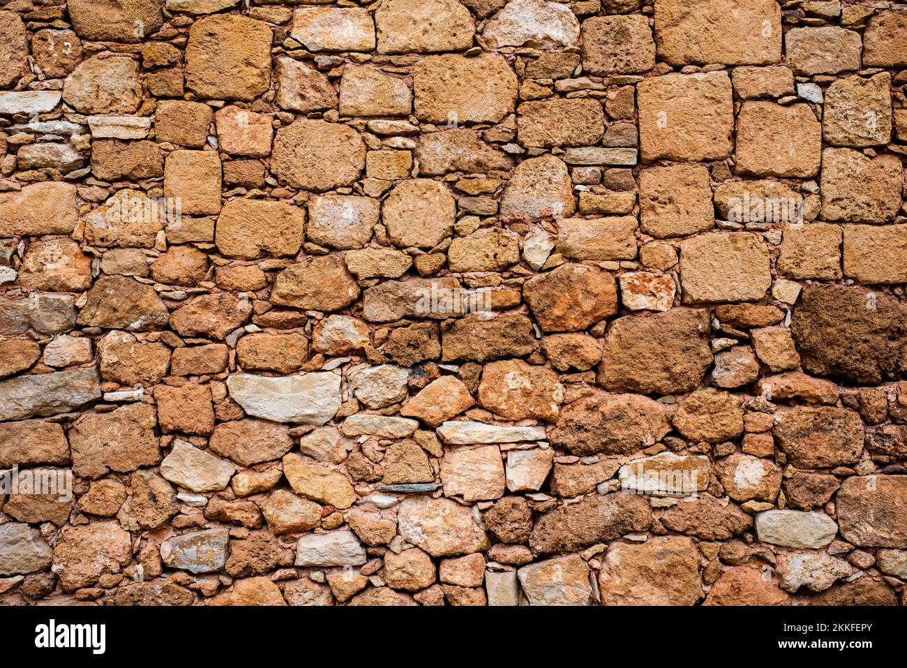Hintergrund. Steinmauer. Gelbe Ziegel. Gelbe Steinmauer. Muster. Stockfoto