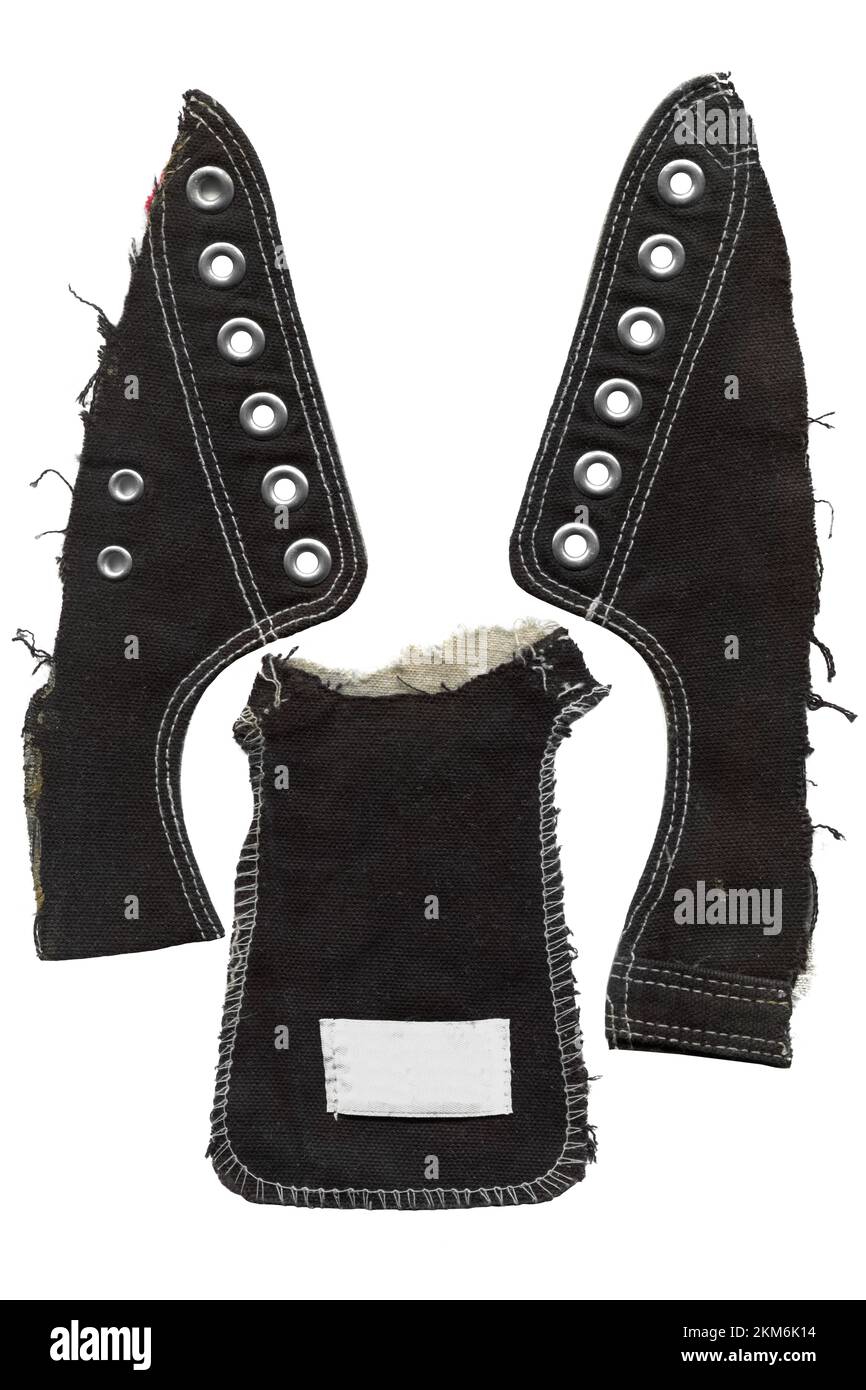 Klassische Elemente im Vintage-Stil aus schwarzen Gummischuhen aus Leinen. Sneakermuster isoliert auf weißem Hintergrund Stockfoto