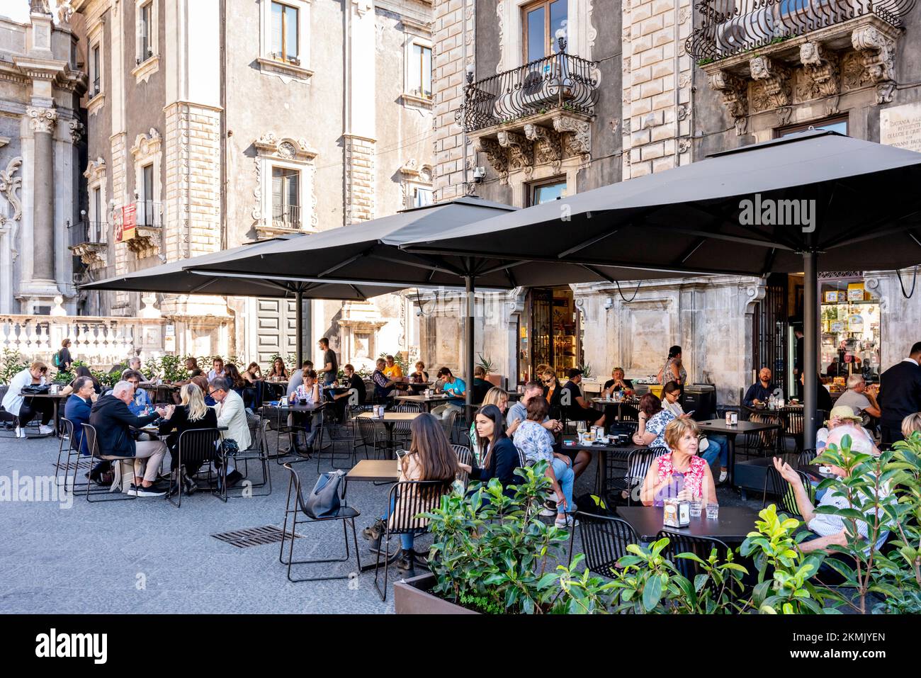 Gäste Sitzen In Einem Café/Restaurant Im Freien Auf Der Piazza Del Duomo, Catania, Sizilien, Italien. Stockfoto