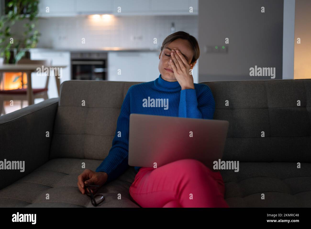 Ungesunde Frau, die an einem Syndrom trockener Augen leidet, halten die Brille und fühlen sich nach der Benutzung des Laptops überlastet. Stockfoto