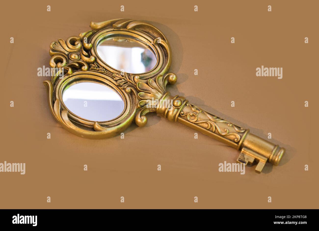 Retro Stil goldene Farbe Schlüssel mit einem Spiegel Stockfoto