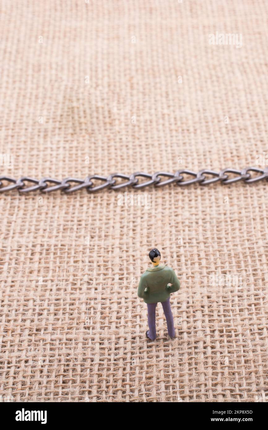 Mann-Figur und Globe mit einer Kette in der Mitte Stockfoto