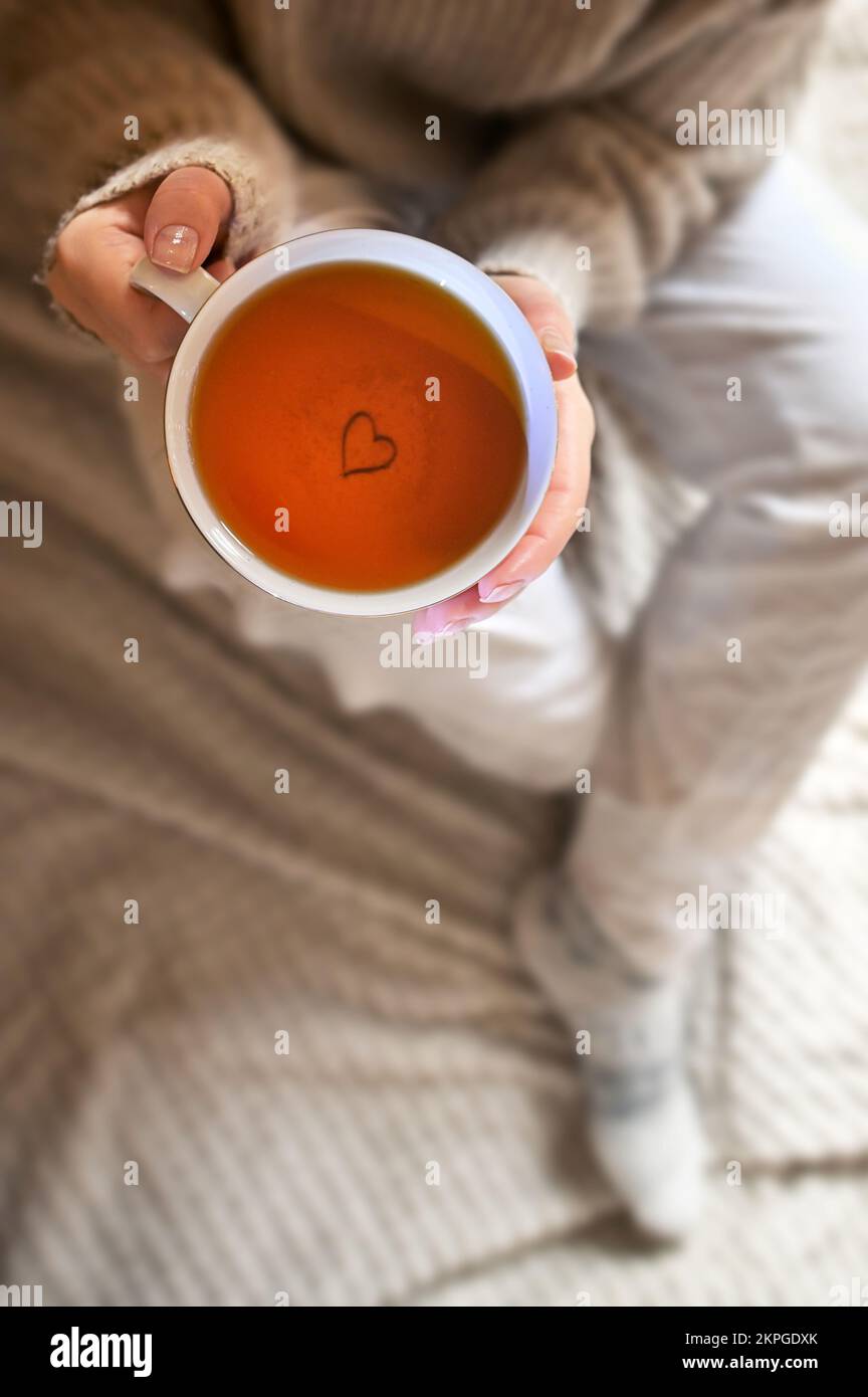 Konzeptionelles Mädchen, das eine Tasse Tee in der Hand hält Stockfoto