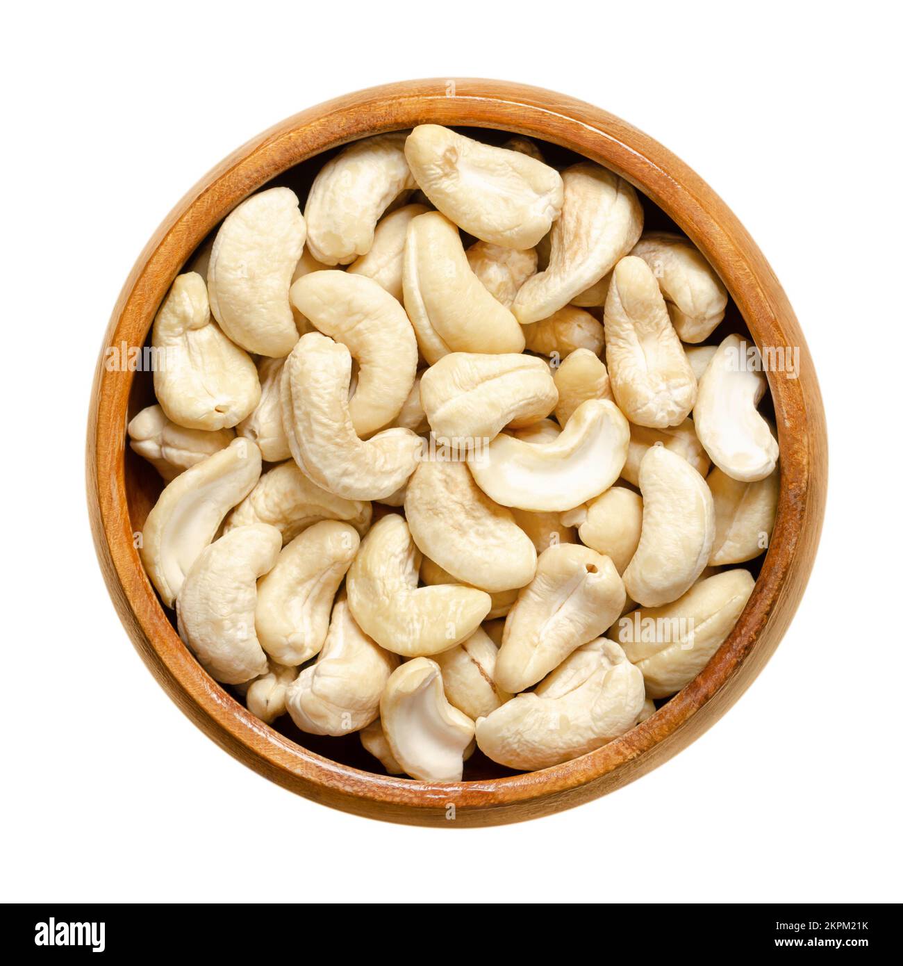 Kaschu-Nüsse, rohe Kaschu-Nüsse in einer Holzschüssel. Samen von geschälten Cashew-Früchten, Anacardium occidentale. Snacknüsse. Stockfoto