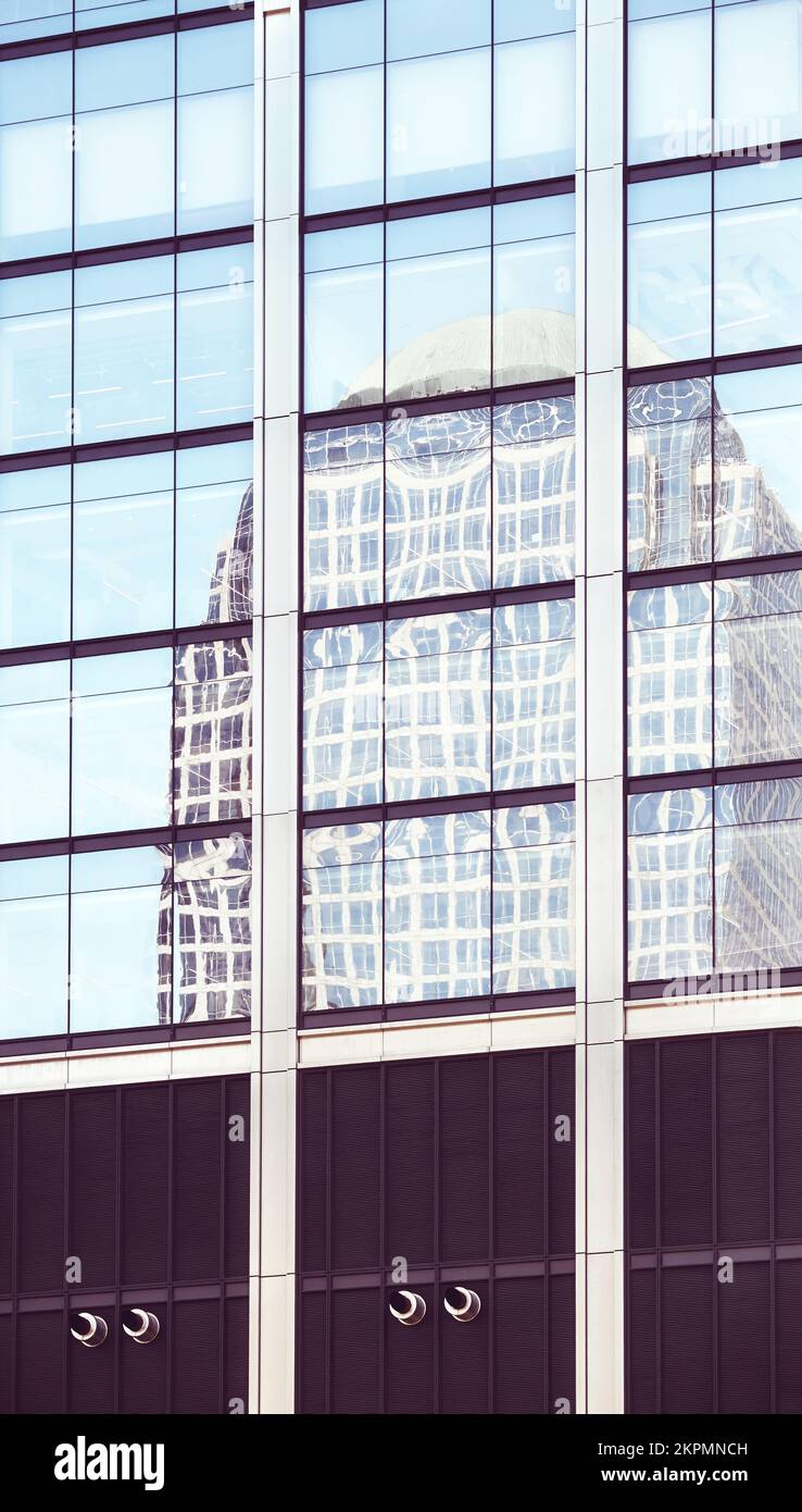Das Gebäude spiegelt sich in den Fenstern eines modernen Wolkenkratzers wider, abstrakter urbaner Hintergrund, Farbtöne angewendet, New York City, USA. Stockfoto