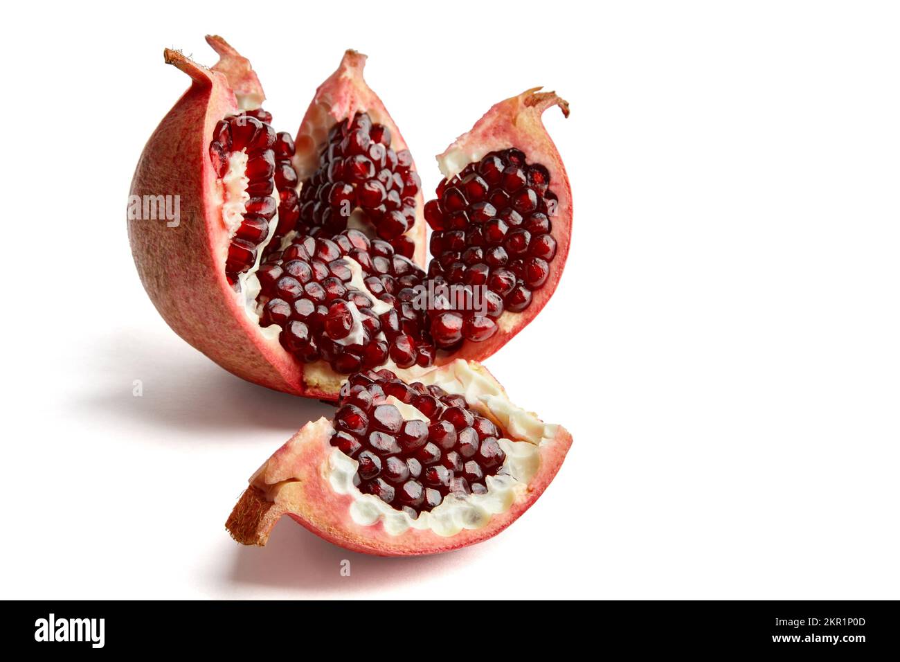 Wunderschön geschnittener und gebrochener reifer Granatapfel isoliert auf weißem Hintergrund Stockfoto