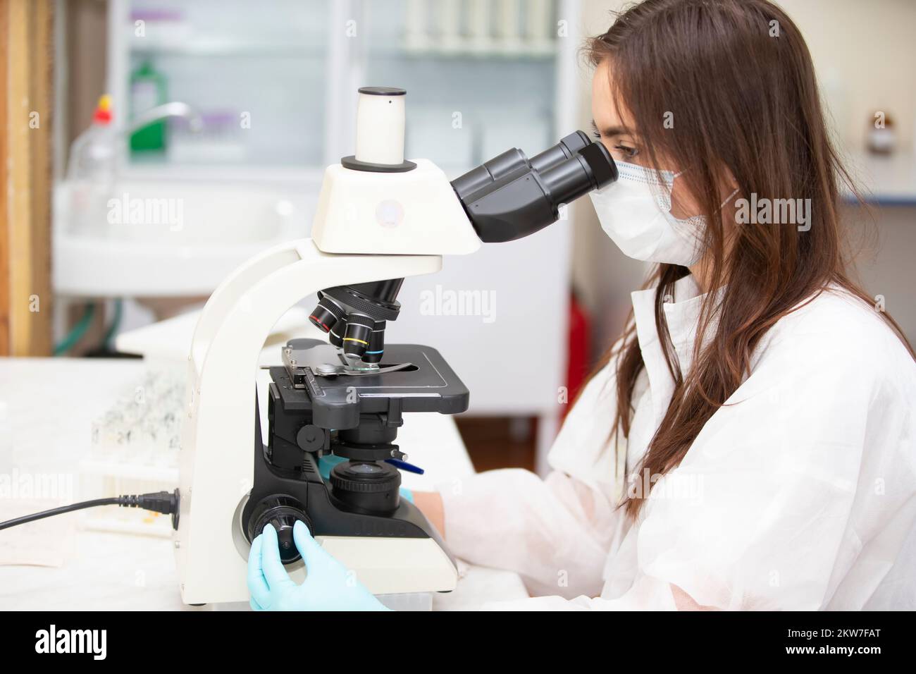 Weißrussland, Gomil, 31. Mai 2021. City Central Hospital.Ein Biologe schaut durch ein Mikroskop. Weibliche Biologin. Eine Laboratoriumsassistentin mit einem Mikroskop Stockfoto