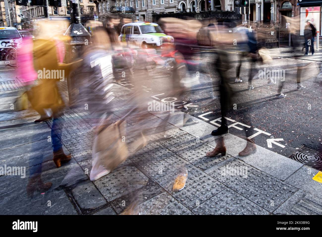 Verschwommenes Bild von Menschen, die eine Straße überqueren Stockfoto