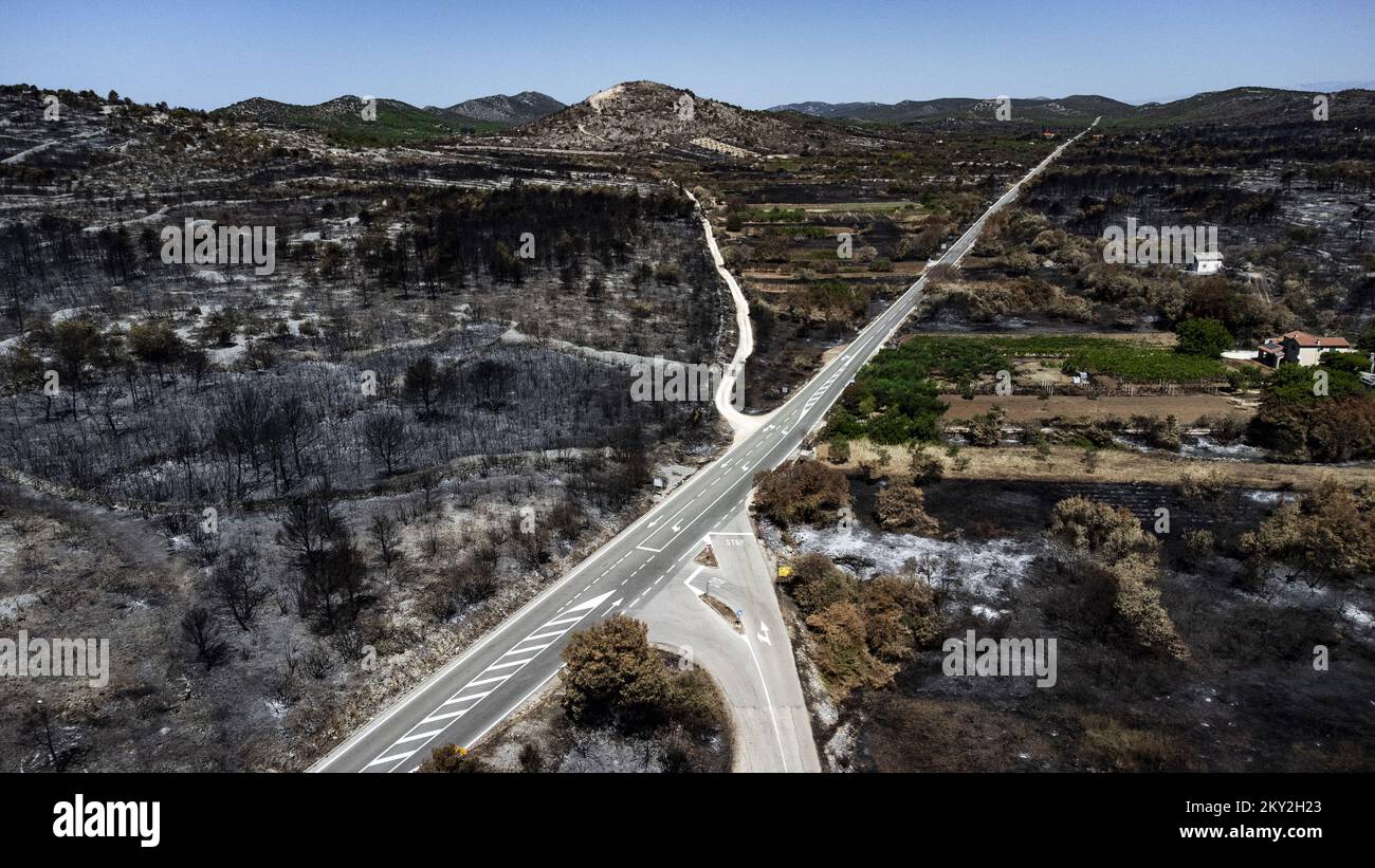 Luftfoto aufgenommen am 19. Juli 2022 zeigt die verbrannte Gegend um Raslina und Zaton in Kroatien. Der Waldbrand, der letzten Mittwoch in den Gebieten Zaton und Raslinje im Bezirk Å ibenik-Knin ausbrach, wurde am Montagmorgen für gelöscht erklärt. Der Brand breitete sich auf schätzungsweise 3.300 Hektar Land aus und verdaute Gras, Unterholz, Holz und landwirtschaftliche Nutzpflanzen. 30 Häuser, mehrere Autos und Boote und drei landwirtschaftliche Maschinen waren im Brandfall niedergebrannt. Foto: Milan Sabic/PIXSELL Stockfoto