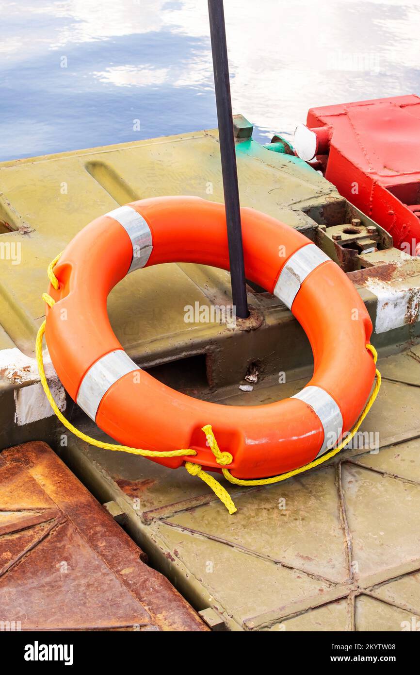 Orangefarbene Rettungsboje am Rand einer Metallbrücke Stockfoto