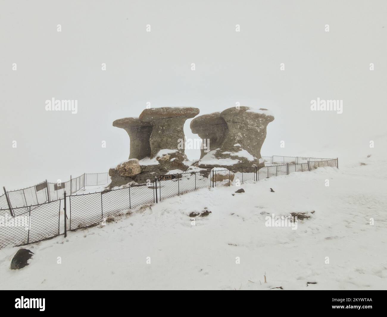 Babele (die alten Damen) Steingruppe, eine natürliche Felsformation im Naturpark Bucegi, im Bucegi-Gebirge Rumäniens, während eines Schneesturms auf einem Stockfoto