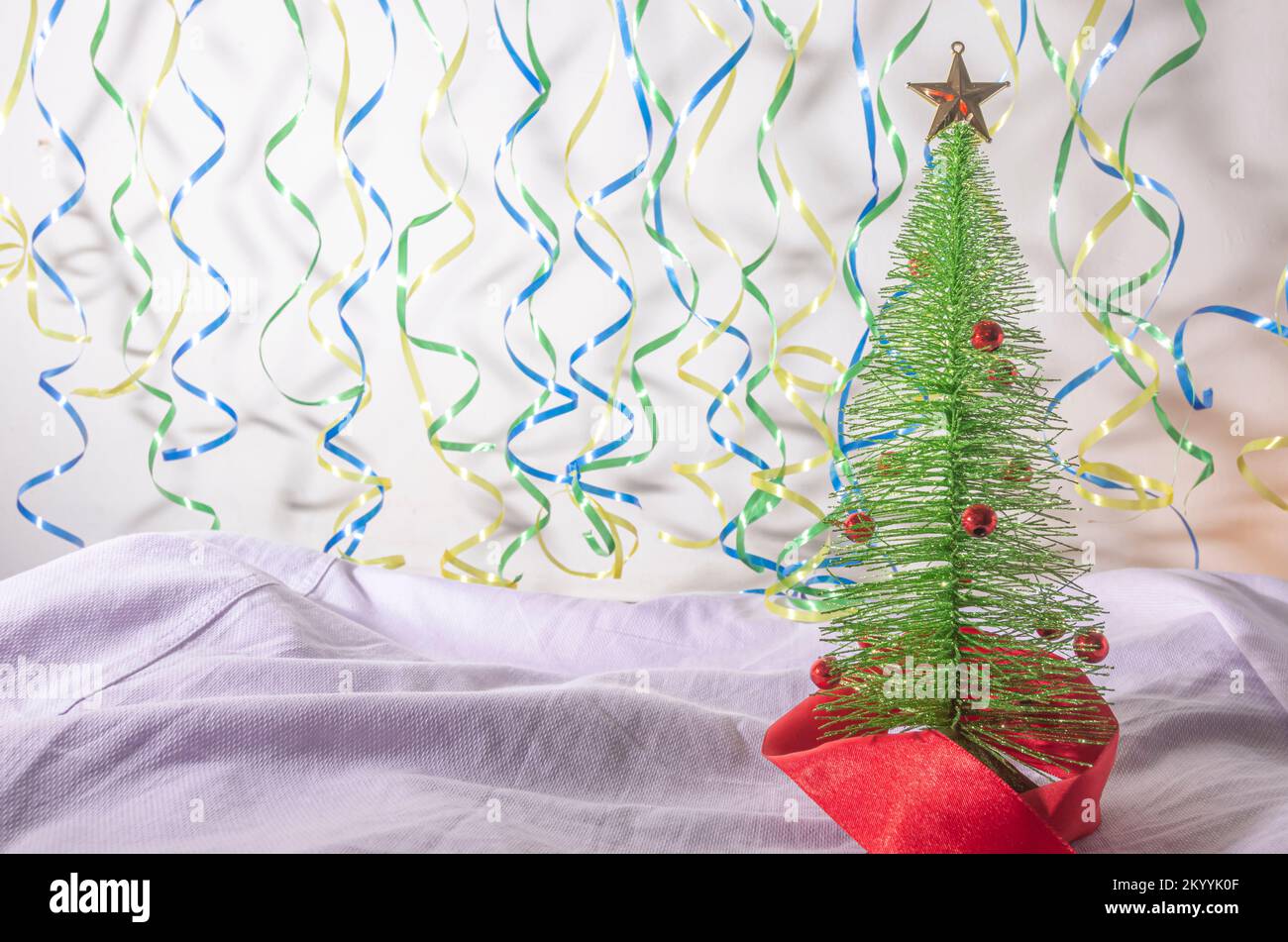 Weihnachtsbaum mit einer Schleifenleine im Hintergrund mit den Farben Brasiliens, brasilianisches Weihnachtskonzept, Stockfoto