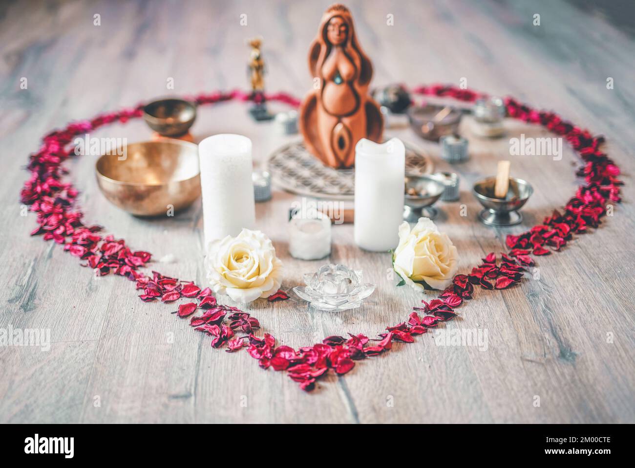 Schöner Altar mit Rosenblättern und Göttin-Statuette. Zeremonienraum. Stockfoto