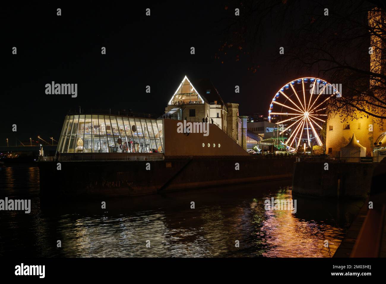 Nachtlandschaft am Rhein und Hintergrund des Hafens Weihnachtsmarkt in der Nähe des Schokoladenmuseums während des Weihnachtsmarkts im Winter. Stockfoto