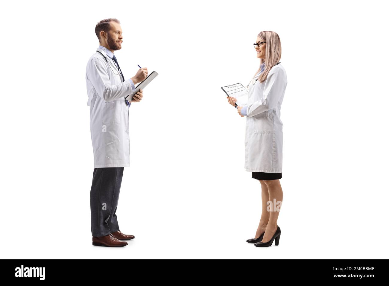 Doktor spricht mit einer Kollegin und schreibt ein Dokument isoliert auf weißem Hintergrund Stockfoto
