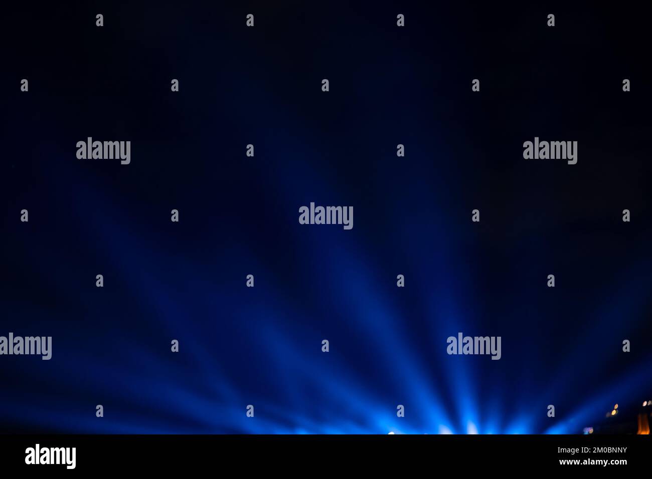 Blaue Strahlen. Hintergrundbild des Projektors mit Lichtstrahlen. Konzeptfoto für Nachtveranstaltung. Stockfoto
