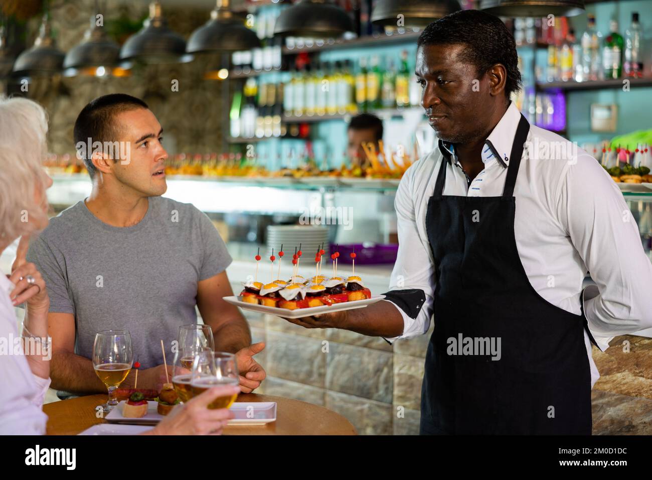 Blick auf den erwachsenen afrikanischen Mann, der Pinchos anbietet Stockfoto