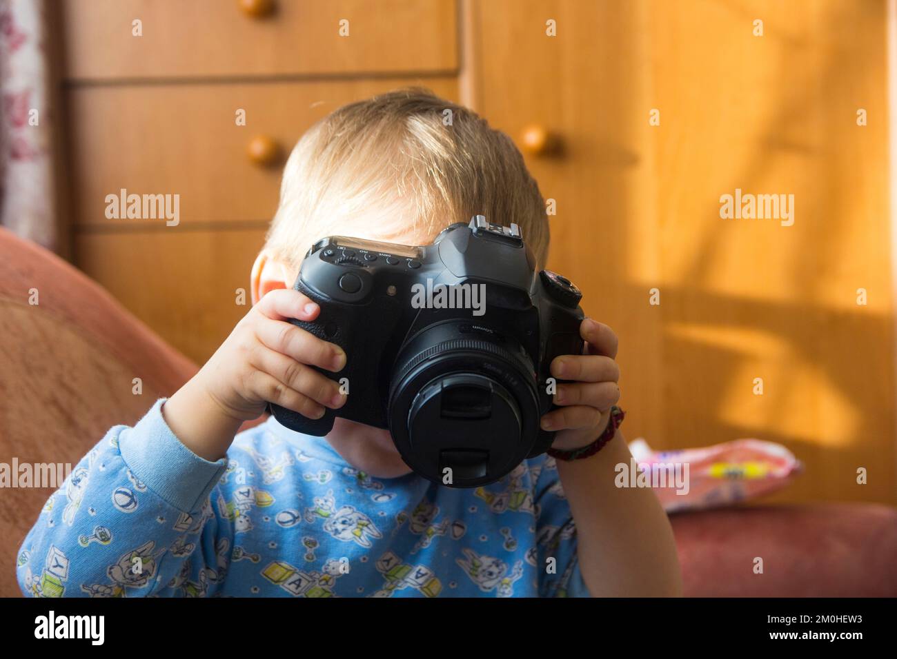 Ein kleines Kind spielt mit einer Nahaufnahme der Kamera. Stockfoto
