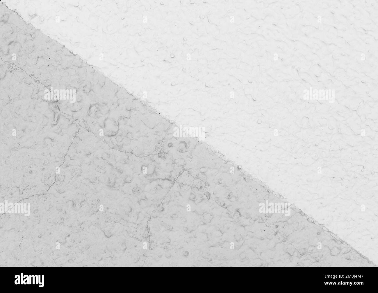 Diagonale Linie auf einer weißen Putzwand mit zwei Farben – Hintergrund mit heller Textur. Stockfoto