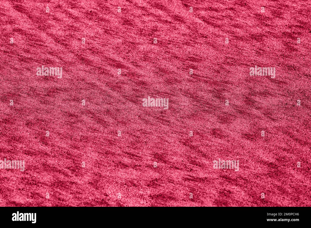Natürlicher Sandmusterhintergrund. Abstrakter Hintergrund für magentafarbene und oberflächliche Textur. Stockfoto