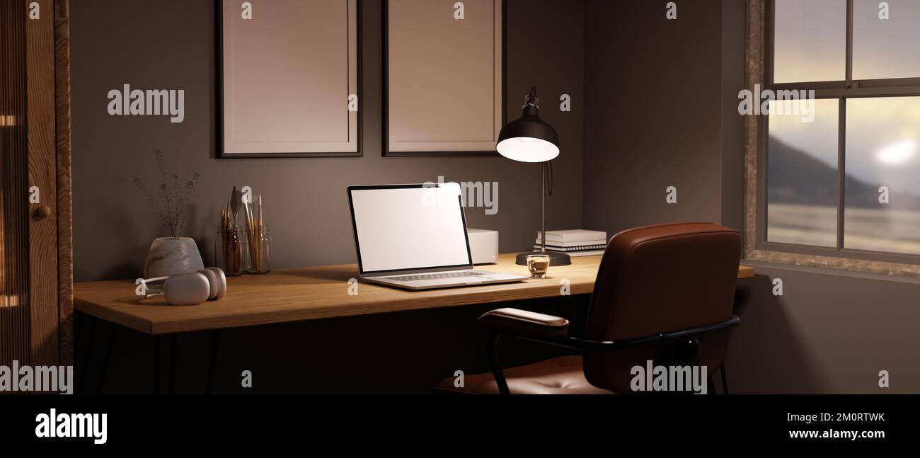 Seitenansicht eines modernen Arbeitsbereichs zu Hause mit Laptop-Modell, Licht von Tischleuchte und Zubehör auf Holztisch an der grauen Wand mit leerem rahmen Stockfoto