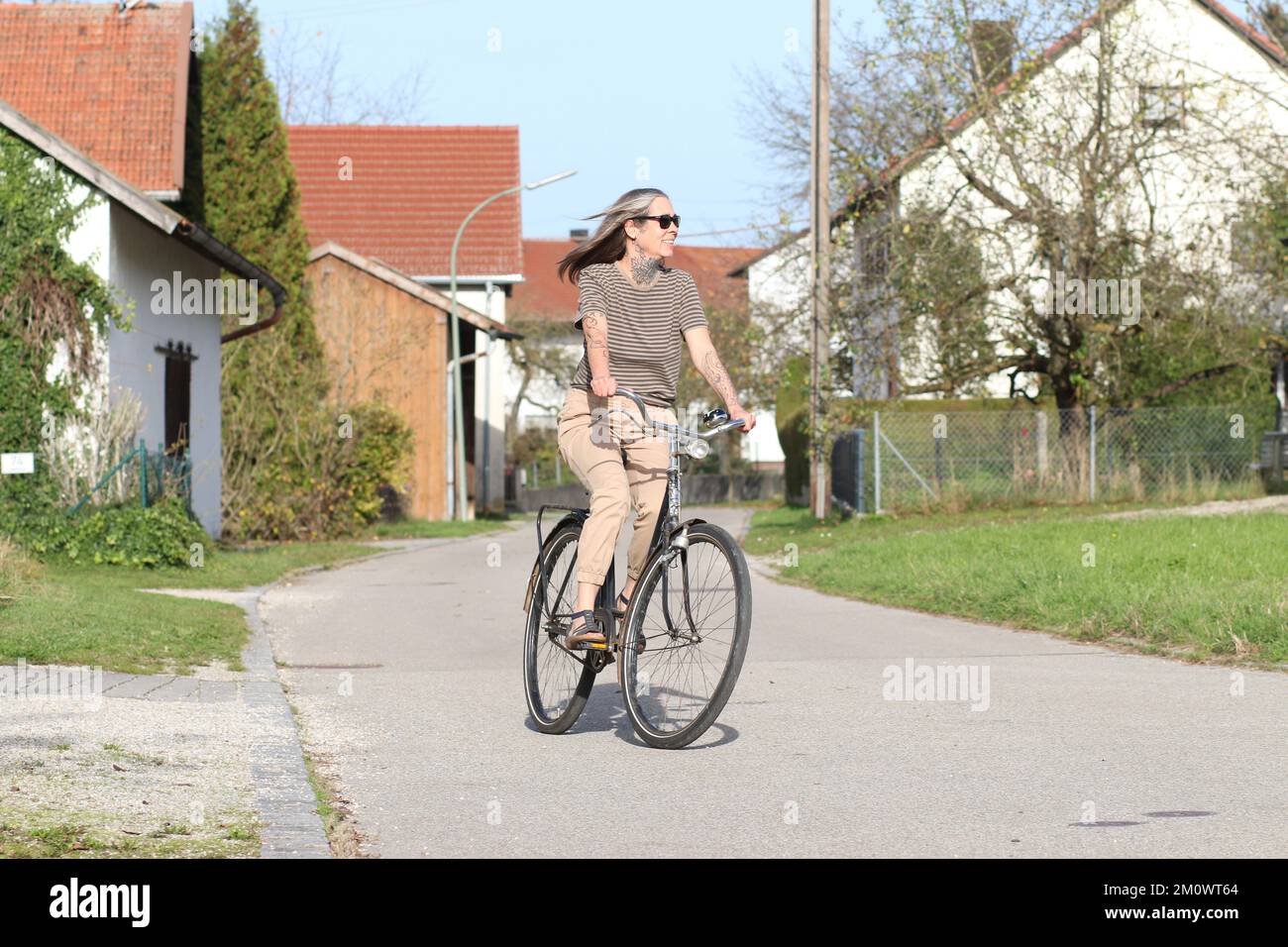 Bestes Alter weibliches Model 50 plus Fitness mit besserer Fahrradalterung. Frau im besten Alter hält sich fit beim Radfahren. Sonnenbrille, Fahrrad, 50 plus. Stockfoto