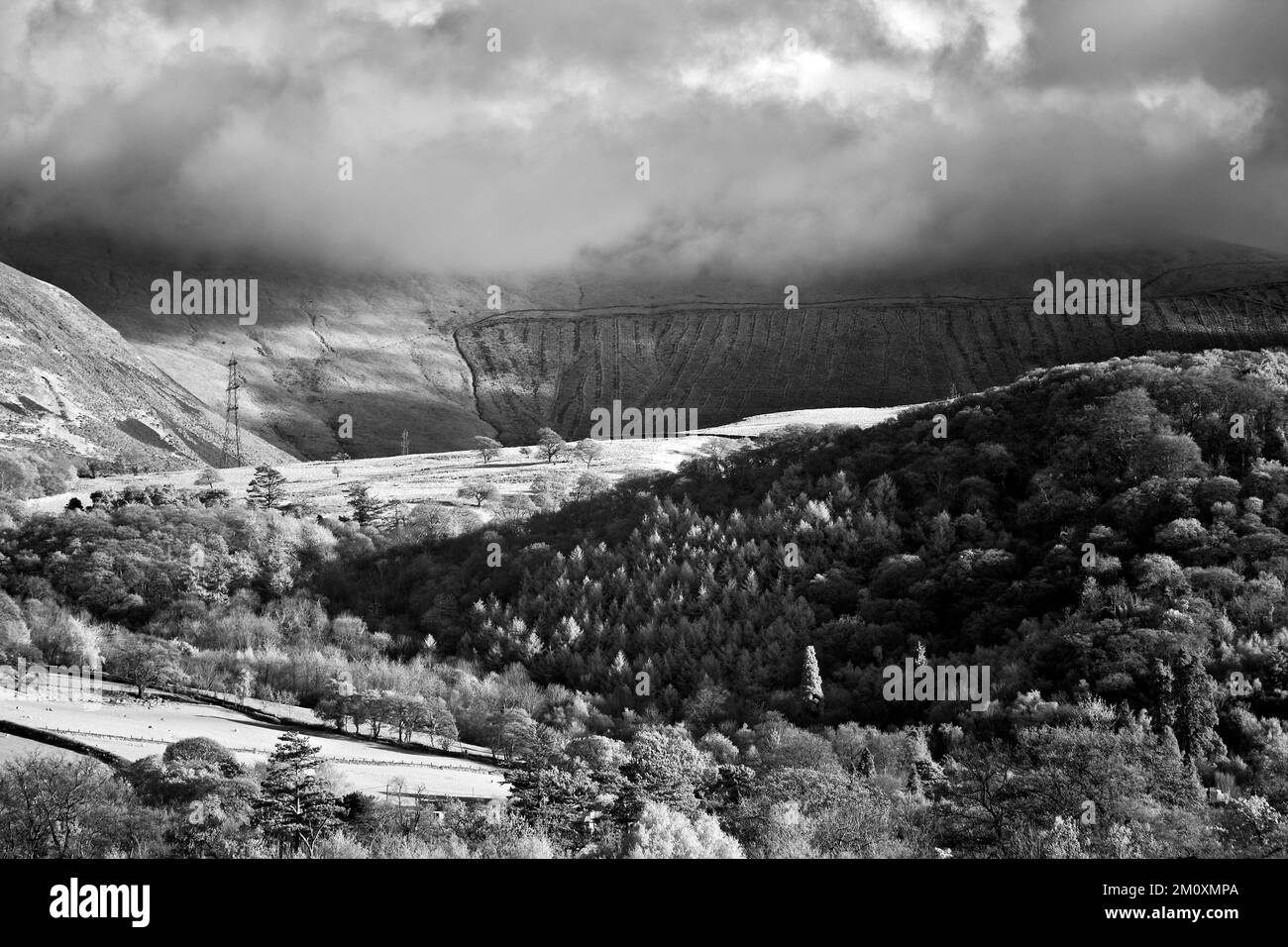 North Snowdonia teilweise bewaldete Berghänge mit Wolkeninvertierung von der Küste von Nordwales in der Nähe von Llanfairfechan Stockfoto