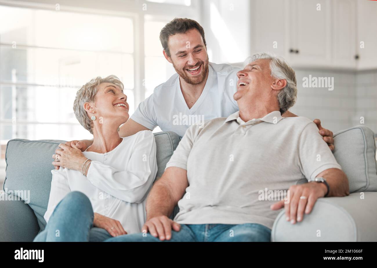 Bitte, kümmere dich um deine Großeltern. Ein reifes Paar, das sich mit seinem Sohn zu Hause auf dem Sofa anfreundet. Stockfoto