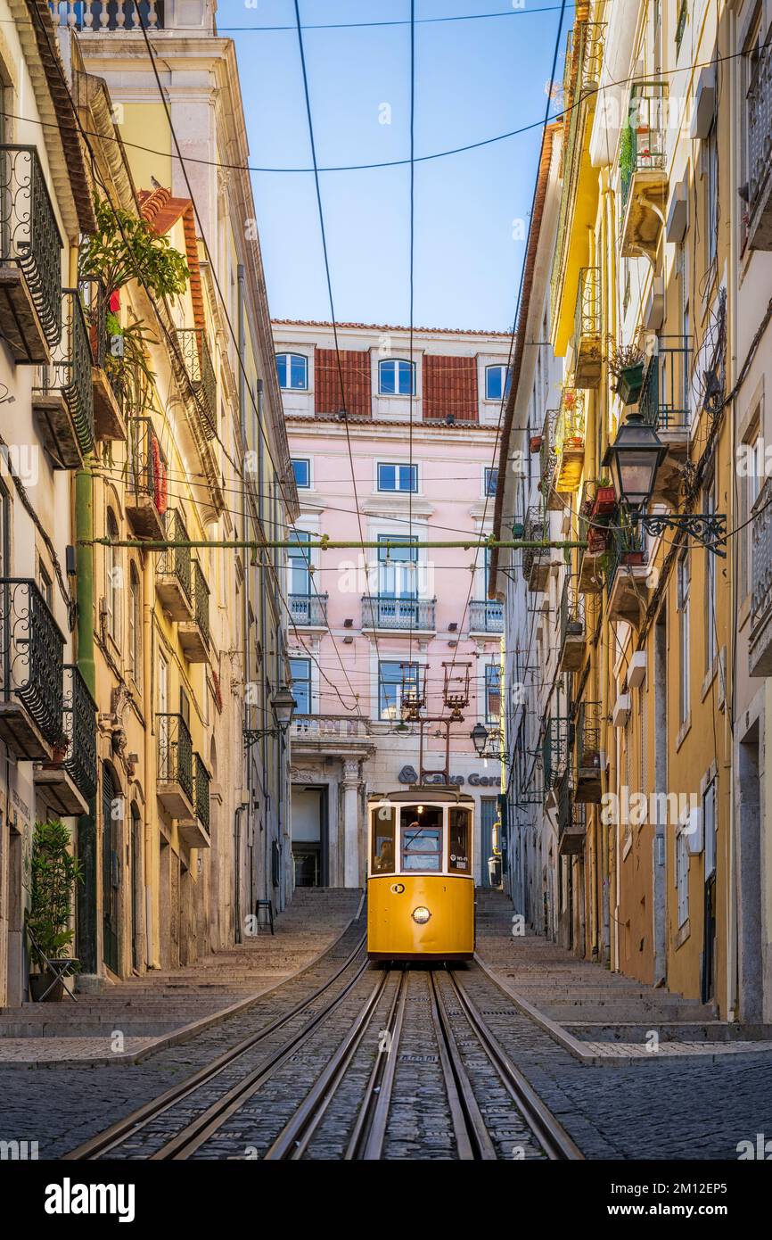 Historische gelbe Straßenbahn in einer steilen Straße in Lissabon, Portugal Stockfoto